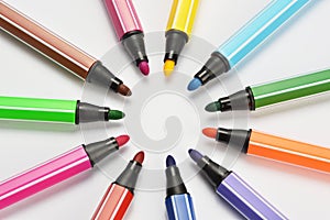 Multi colored felt tip pens on white background