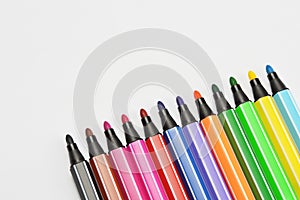 Multi colored felt tip pens on white background