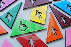 Multi-colored figures and one with a Disabled person sign as a concept of inclusivity and diversity.