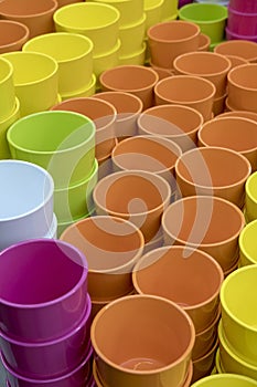 Multi-colored flower pots of round shape on the table