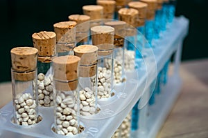 Multi-colored granules of micronutrient fertilizer in test tubes in a row