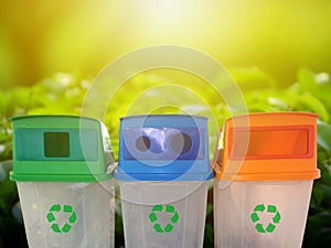 Multi colored green, blue, orange trash bins isolated on white background. Trash for cleanliness recycling concept