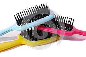 Multi-colored hair combs on an isolated white background.