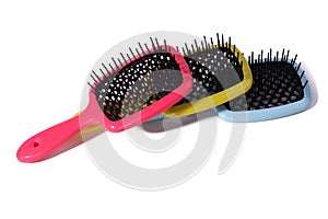 Multi-colored hair combs on an isolated white background.