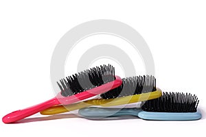 Multi-colored hair combs on an isolated white background.