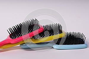 Multi-colored hair combs on an isolated white background.