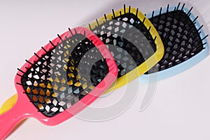 Multi-colored hair combs on an isolated white background.