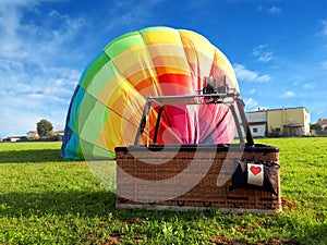 Multi colored hot air balloon with red heart in the field photo