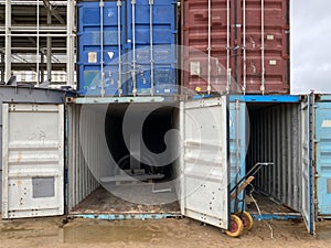 Multi-colored iron industrial sea containers for international transportation of goods according to the logistic rules of photo