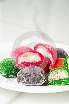 Multi-colored Japanese cakes Mochi in a white plate