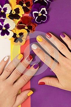 Multi-colored juicy manicure on short female nails