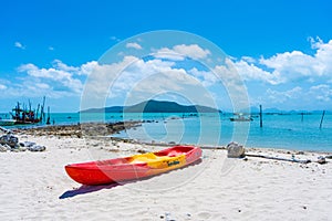 Multi-colored kayaks on a tropical sandy beach. Kayak rental. Tourist entertainment