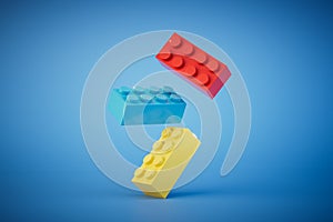 multi-colored Lego blocks flying across a blue background. 3D render