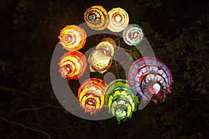 Multi-colored lights adorn the night beach of Ao Nang. Traditional Thai motifs