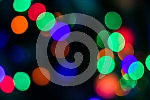Multi-colored lights with red, green, purple, orange colored on the dark background.