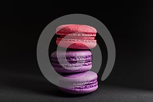 Multi-colored macaroons on a dark background. International Women`s Day. French national cuisine. Food shot