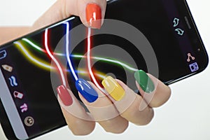 Multi-colored manicure on a different form of nails with a gadget