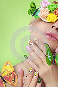 Multi-colored manicure on nails with a design of butterflies.