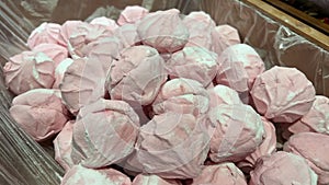 Multi-colored marshmallows on store shelves pink green dye in sweets snack made from baked apples made from pectin