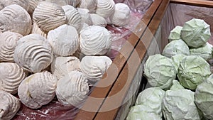 Multi-colored marshmallows on store shelves pink green dye in sweets snack made from baked apples made from pectin