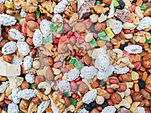 A multi-colored mixture of nuts, dried fruits and berries on the counter of the farmers market
