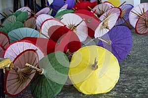 Multi colored mulberry paper umbrellas on the floor