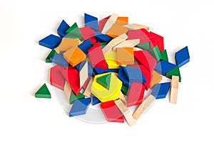 Multi Colored pattern blocks on a white wooden background.Isolate