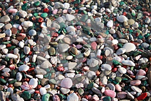 Multi-colored pebbles on the beach on Adriatic Sea. Pebble background, texture