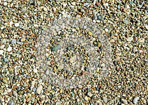 Multi-colored pebbles on the shores of the Mediterranean Sea. Pebble background. Coast. Abstract background with round pebble