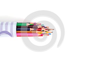 Multi-colored pencils in a tube on a white background. School supplies and stationery concept