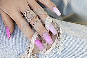 Multi-colored pink manicure with long nails.