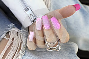 Multi-colored pink manicure with long nails.