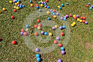 Multi-colored plastic balls on outdoor grass