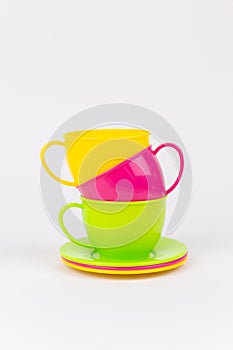 multi-colored plastic cups and plates on a white background kitchen set