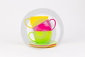 multi-colored plastic cups and plates on a white background kitchen set