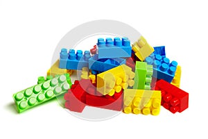 Multi-colored plastic designer building blocks on a white background. Colorful construction kit for kids
