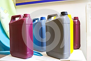 Multi-colored plastic yellow red gray blue yellow cans with a handle for liquids, fuels, oils