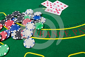 Multi-colored poker cards, chips laid out on a new green poker table. Poker concept