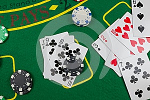 Multi-colored poker cards, chips laid out on a new green poker table. Poker concept