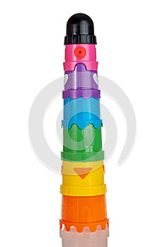 Multi-colored pyramid children`s toy, folding design, isolated on a white background, close-up, toys for kids for the development