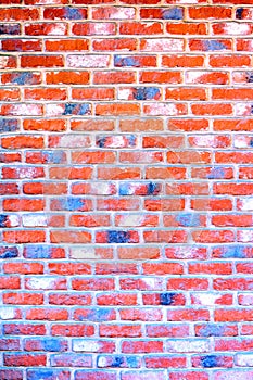 Multi-colored red brick wall.