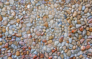 Rounded pebbles embedded in a concrete wall