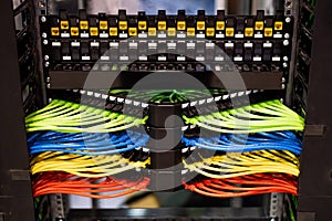 Multi-colored rows of network cables are connected to the system