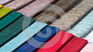 Multi colored set of upholstery fabric samples for selection, collection of textile swatches