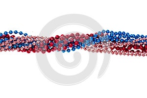 Multi colored shiny mardi gras beads on white background