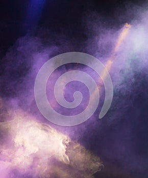 Multi-colored smoke at the concert at night
