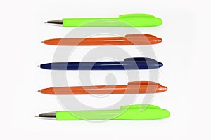 Multi-colored stationery plastic writing pens on a white background