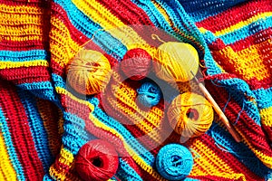 Multi-colored striped crochet, crochet hook and yarn