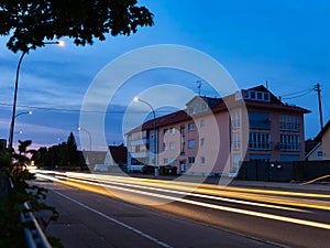 Only multi-colored stripes from the headlights of the car remained after taking a long exposure