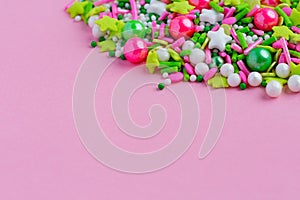 Multi-colored Sugar sprinkle dots, decoration for cake and bekery in pink background. Easter. Copy space